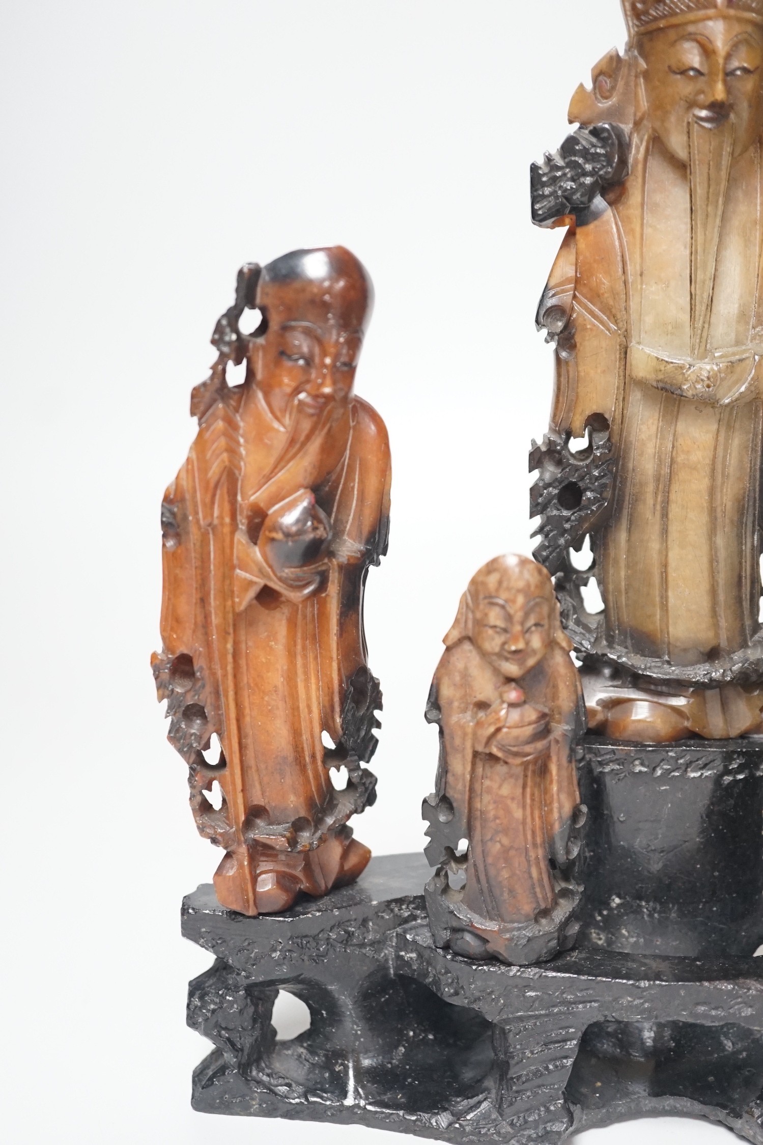 An early 20th century Chinese carved soapstone group of five deities on a rockwork base, 23cm